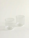 Two clear ribbed glass tumblers on a clean white background.