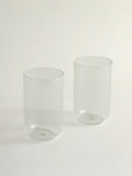 Two clear ribbed glass tumblers on a clean white background.