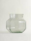 A clear glass vase with a rounded, multi-sided geometric body and a flared rim, shown on a plain light background.