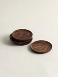 A set of wooden coasters with brass thread detailing on a white background