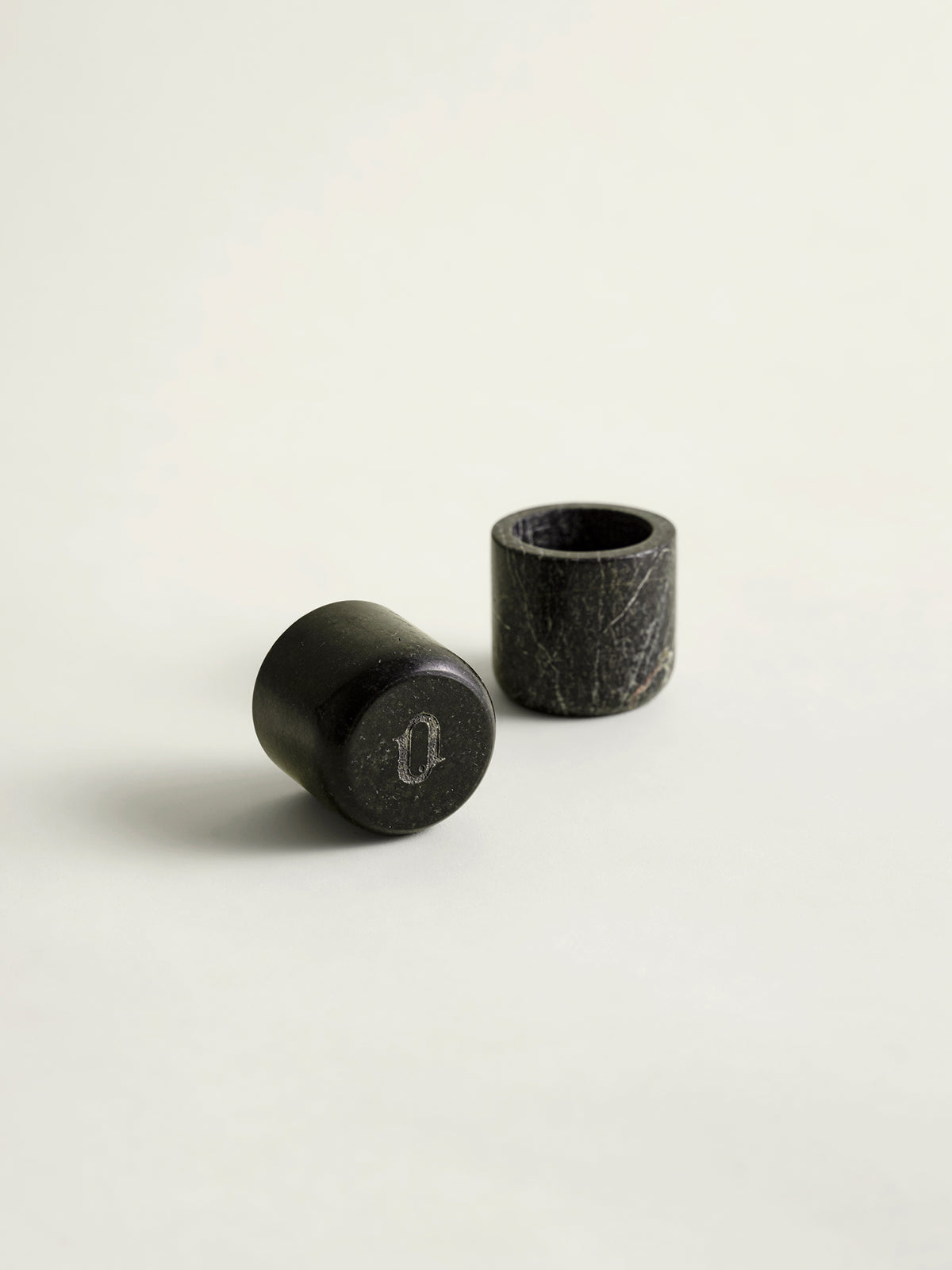 Two rainforest green marble candle holders on a white background