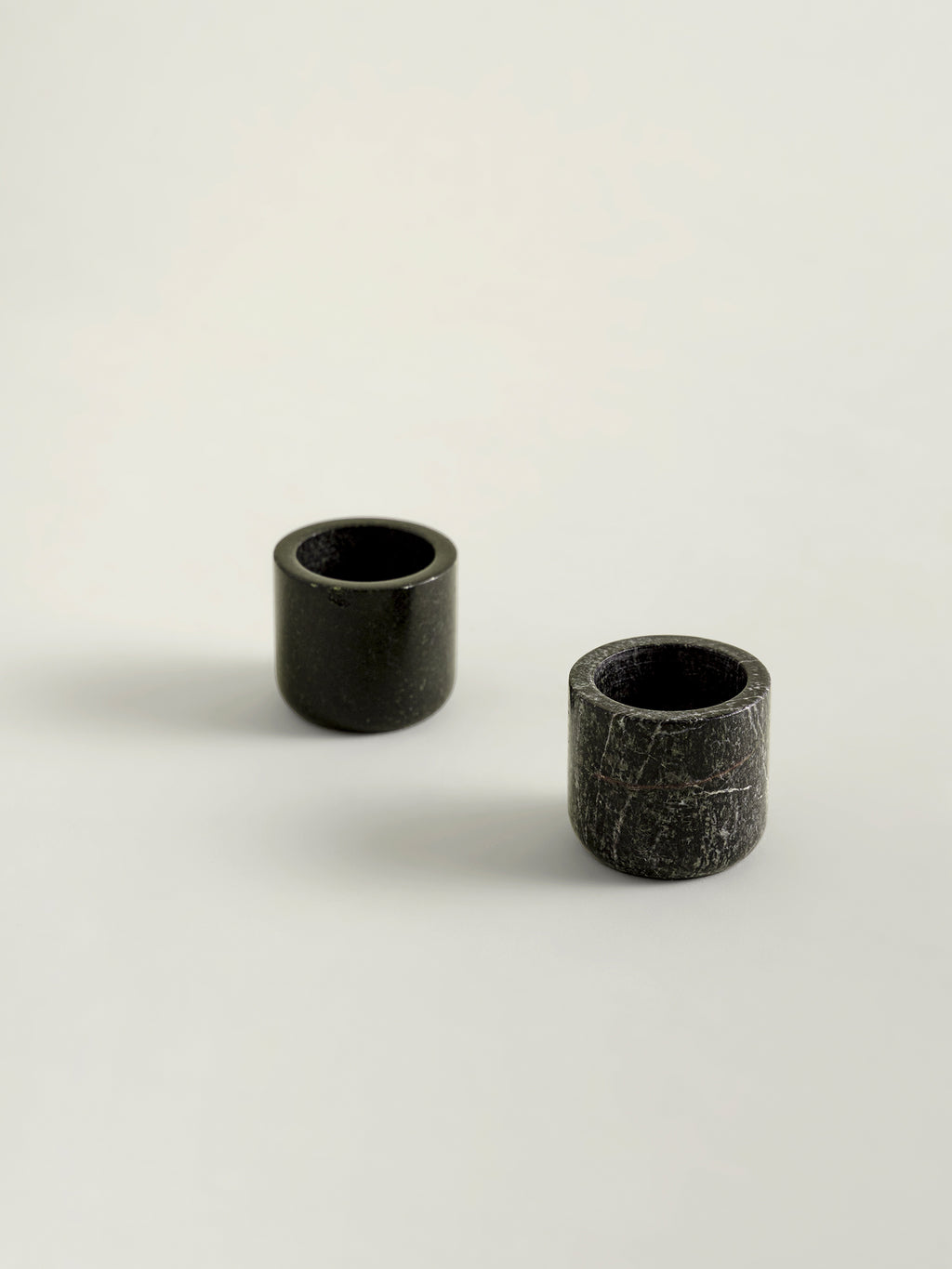 Pair of rainforest green marble candle holders on a white background